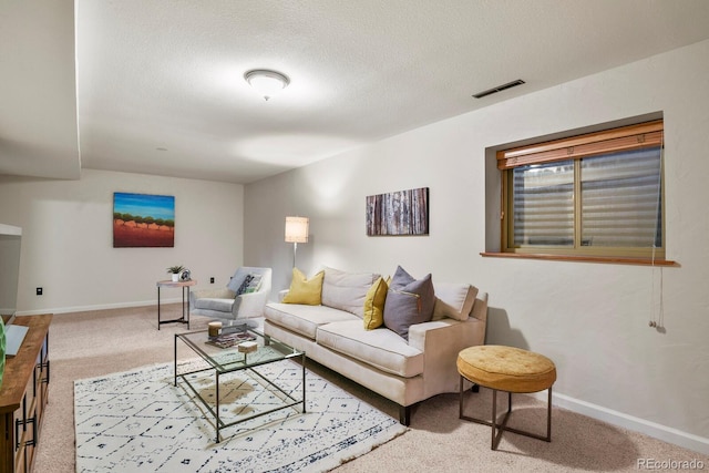 carpeted living area with baseboards, visible vents, and a textured ceiling