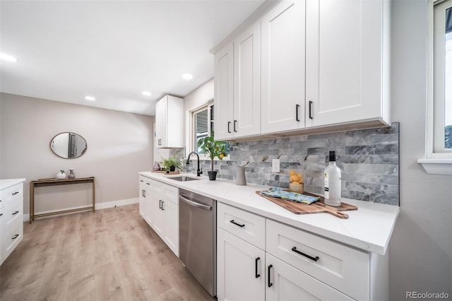 7150 Beach St, Westminster, CO 80030 - kitchen featuring dishwasher, decorative backsplash, light wood-style flooring, light countertops, and recessed lighting