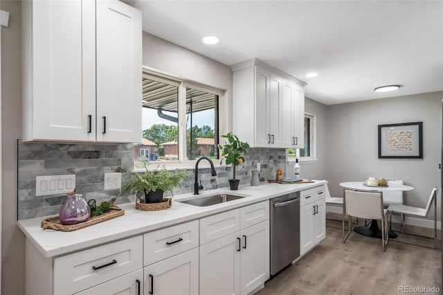 7150 Beach St, Westminster, CO 80030 - kitchen featuring stainless steel dishwasher, plenty of natural light, light wood finished floors, decorative backsplash, and recessed lighting