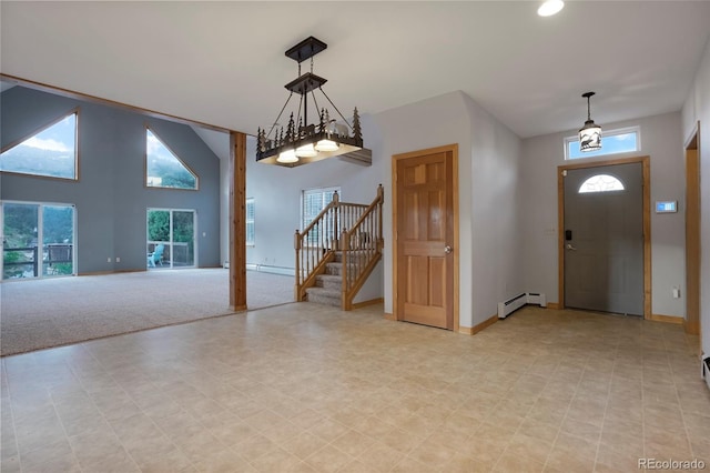 entryway with a baseboard radiator and a high ceiling