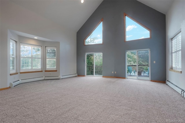 interior space with a wealth of natural light, carpet floors, high vaulted ceiling, and baseboard heating