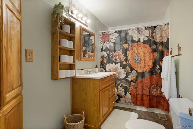 bathroom featuring tile patterned flooring, vanity, toilet, and a shower with curtain