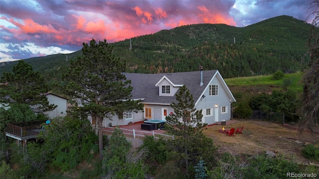 exterior space featuring a hot tub and a mountain view