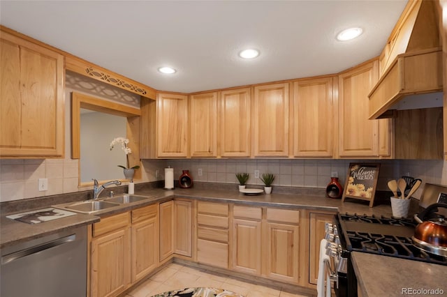 kitchen with light tile patterned flooring, appliances with stainless steel finishes, sink, and light brown cabinets