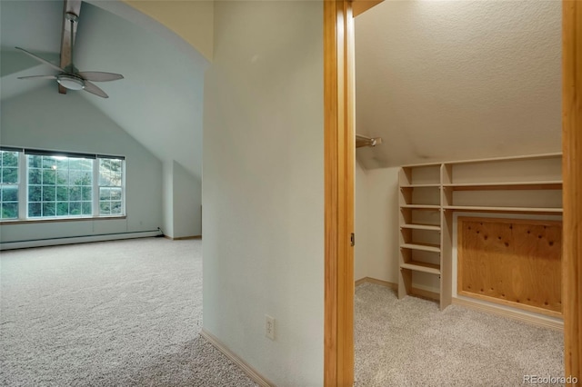 bonus room with ceiling fan, a baseboard radiator, vaulted ceiling, and light carpet