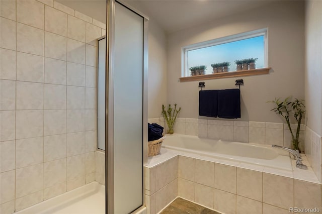 bathroom with shower with separate bathtub