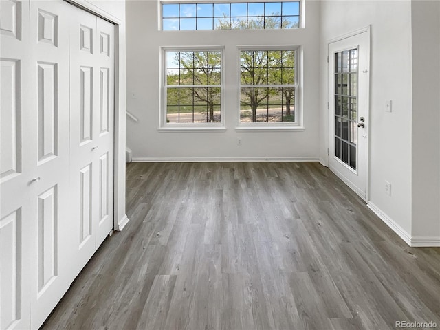 foyer entrance with wood finished floors and baseboards