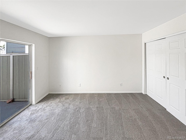 unfurnished bedroom featuring carpet floors and baseboards