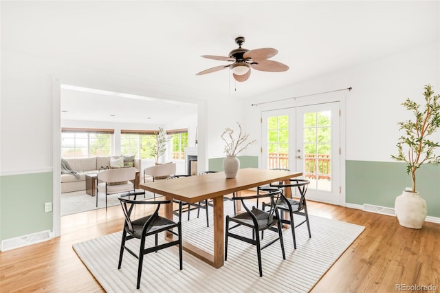 6535 Balsam St, Arvada, CO 80004 - dining area with light wood-style flooring, french doors, a ceiling fan, and baseboards