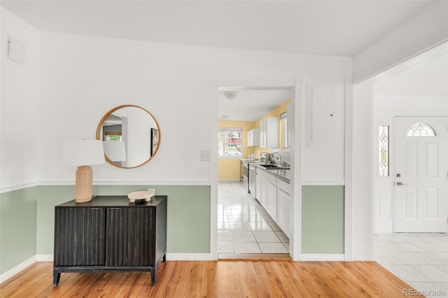 6535 Balsam St, Arvada, CO 80004 - entryway with light wood-style flooring and baseboards
