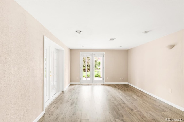 6535 Balsam St, Arvada, CO 80004 - empty room with light wood-style floors, baseboards, and french doors