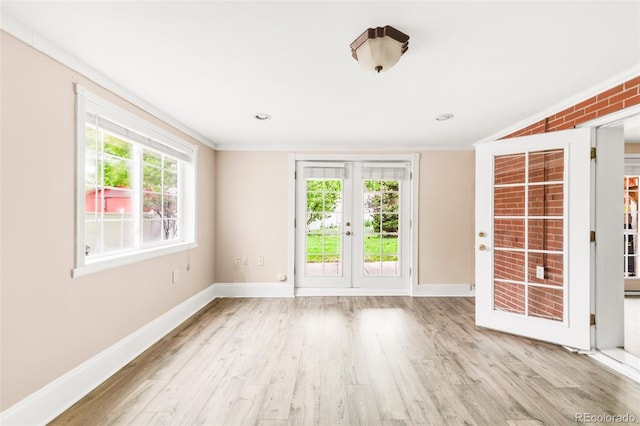 6535 Balsam St, Arvada, CO 80004 - empty room featuring ornamental molding, baseboards, wood finished floors, and french doors