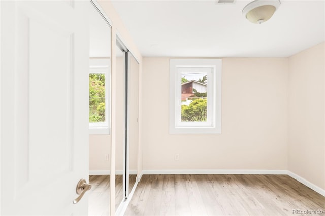 6535 Balsam St, Arvada, CO 80004 - unfurnished bedroom with multiple windows, light wood-style floors, and baseboards