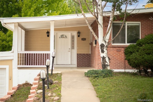 6535 Balsam St, Arvada, CO 80004 - property entrance with brick siding and a porch