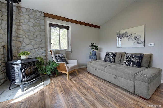 11669 S Upper Ranch Dr, Pine, CO 80470 - living room featuring a wood stove, vaulted ceiling, wood finished floors, and baseboards