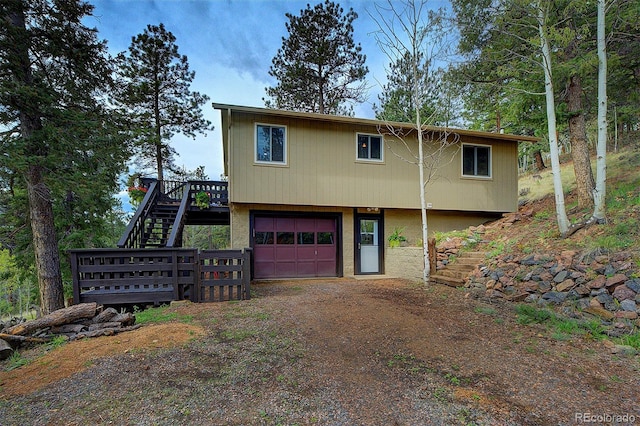 11669 S Upper Ranch Dr, Pine, CO 80470 - view of front of property featuring stairs, a garage, dirt driveway, and a deck