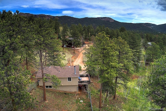 11669 S Upper Ranch Dr, Pine, CO 80470 - aerial view of property and surrounding area featuring a heavily wooded area and a mountain backdrop