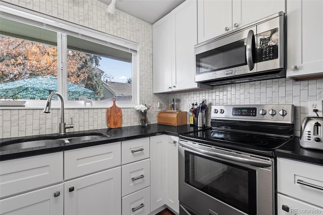 kitchen featuring white cabinetry, sink, appliances with stainless steel finishes, and tasteful backsplash