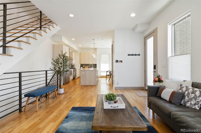 2409 Court Pl, Denver, CO 80205 - living area with light wood-style floors, baseboards, plenty of natural light, and recessed lighting