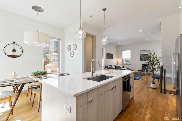 2409 Court Pl, Denver, CO 80205 - kitchen with a sink, light countertops, stainless steel appliances, light wood-type flooring, and modern cabinets