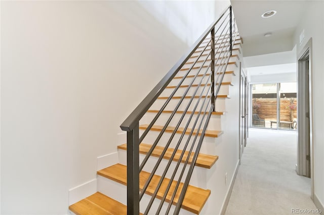 2409 Court Pl, Denver, CO 80205 - staircase featuring baseboards and carpet floors