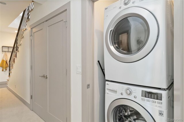 2409 Court Pl, Denver, CO 80205 - clothes washing area with stacked washing maching and dryer, baseboards, and laundry area