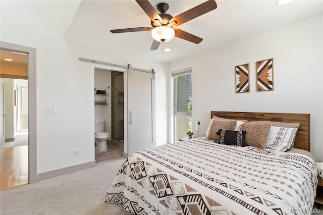 2409 Court Pl, Denver, CO 80205 - carpeted bedroom with recessed lighting, a ceiling fan, a barn door, and ensuite bath