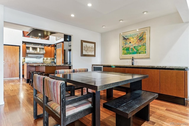 dining room with recessed lighting and light wood-style flooring