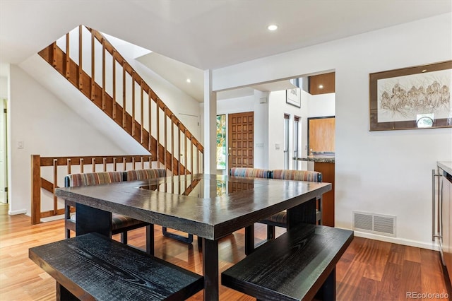 dining space with recessed lighting, visible vents, light wood-style flooring, and stairway