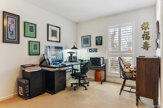 office featuring plenty of natural light, light colored carpet, and baseboards