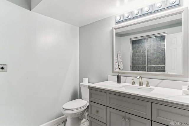 bathroom featuring baseboards, toilet, marble finish floor, and vanity