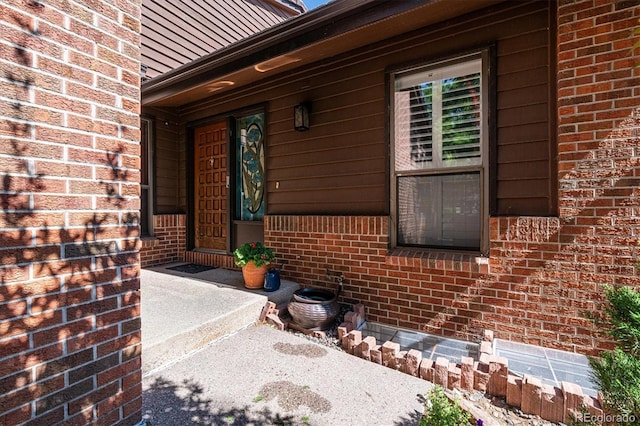 property entrance with brick siding