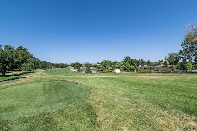 view of yard with view of golf course and a water view