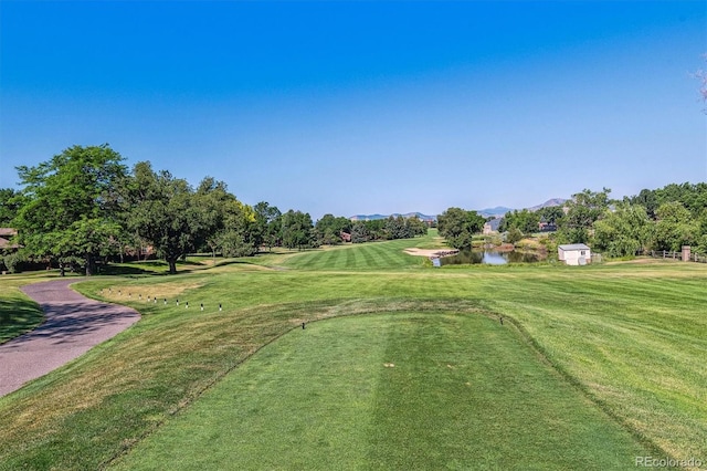 surrounding community featuring a yard and a water and mountain view