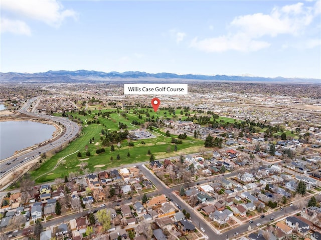 drone / aerial view featuring a water and mountain view and a residential view