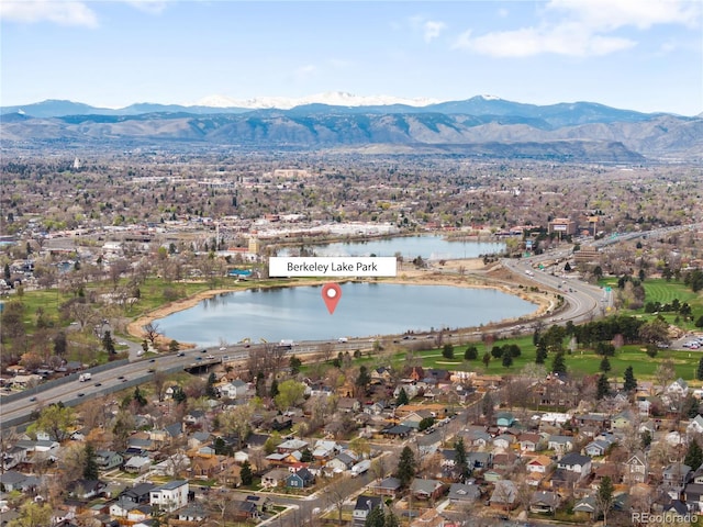drone / aerial view with a water and mountain view and a residential view