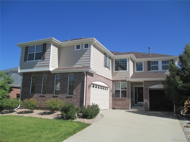 traditional home with an attached garage, a front yard, driveway, and brick siding