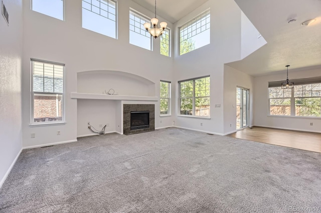 24763 E Crestridge Pl, Aurora, CO 80016 - unfurnished living room with baseboards, a chandelier, and carpet