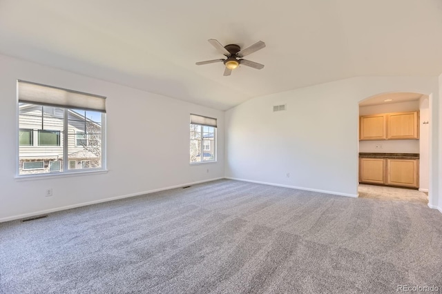 24763 E Crestridge Pl, Aurora, CO 80016 - unfurnished room featuring light carpet, baseboards, arched walkways, a ceiling fan, and vaulted ceiling