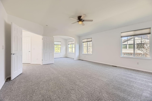 24763 E Crestridge Pl, Aurora, CO 80016 - carpeted spare room featuring visible vents, baseboards, ceiling fan, arched walkways, and vaulted ceiling