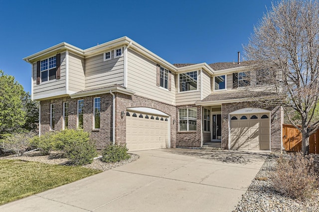 24763 E Crestridge Pl, Aurora, CO 80016 - traditional-style home featuring concrete driveway, brick siding, an attached garage, and fence