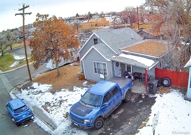 view of front of house with fence and roof with shingles