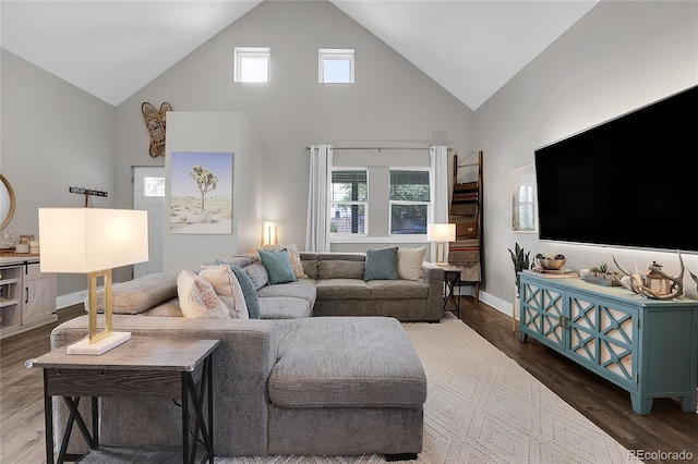 living room with dark wood-type flooring and high vaulted ceiling