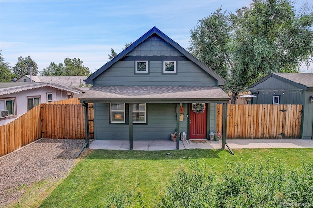 bungalow-style home featuring a front yard and a patio area