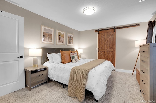 carpeted bedroom featuring a barn door