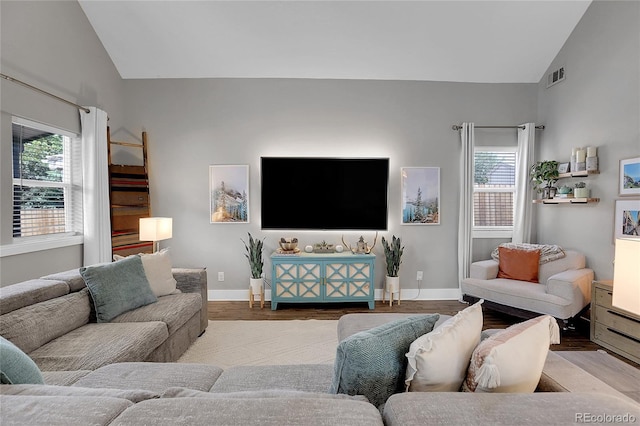 2310 S Decatur St, Denver, CO 80219 - living room with lofted ceiling, wood finished floors, plenty of natural light, and baseboards