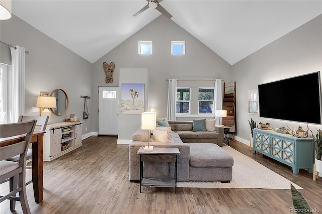 2310 S Decatur St, Denver, CO 80219 - living room featuring high vaulted ceiling, a ceiling fan, light wood-type flooring, and baseboards