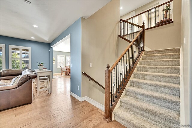 stairs featuring hardwood / wood-style flooring