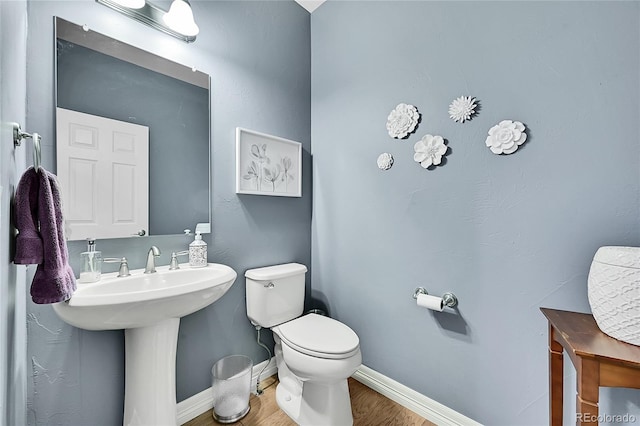 bathroom featuring hardwood / wood-style floors and toilet