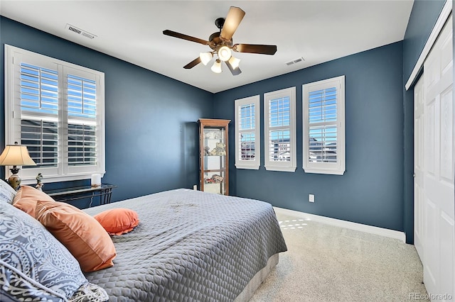 carpeted bedroom with a closet and ceiling fan